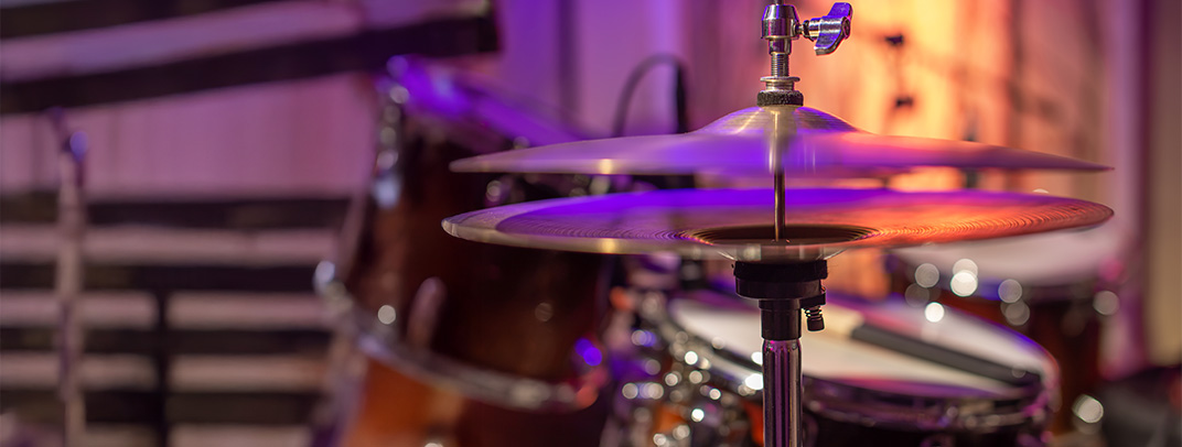 Image of a cymbal on a drum set crashing