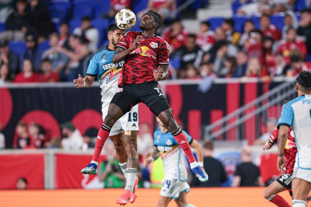 Corey Burke goes for a header in a game versus Sporting Kansas City.
