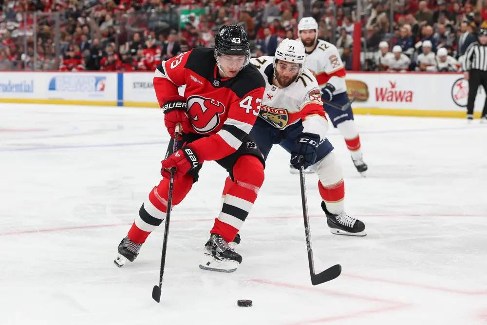 Devils Defenseman Luke Hughes Battles For the Puck