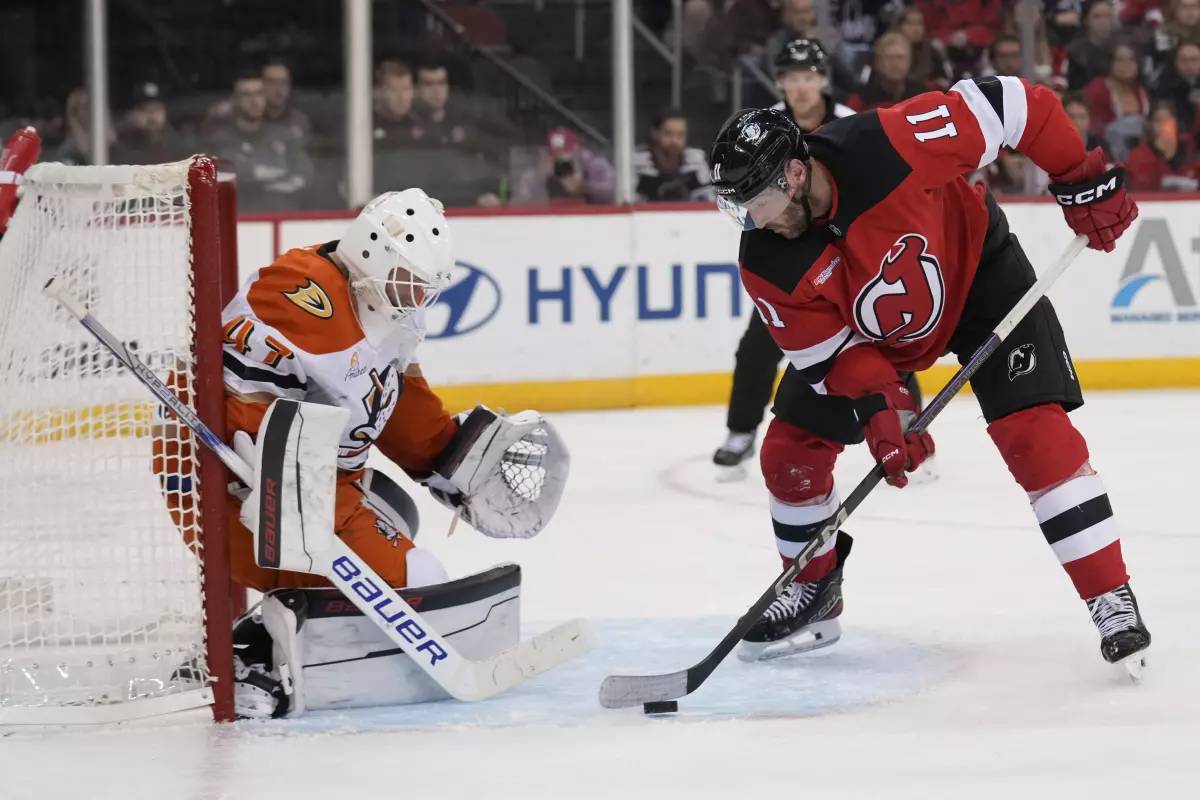 New Jersey’s Stefan Noesen, right, scores past Ducks goalie James Reimer during the second period of the Devils’ 6-2 win Sunday.