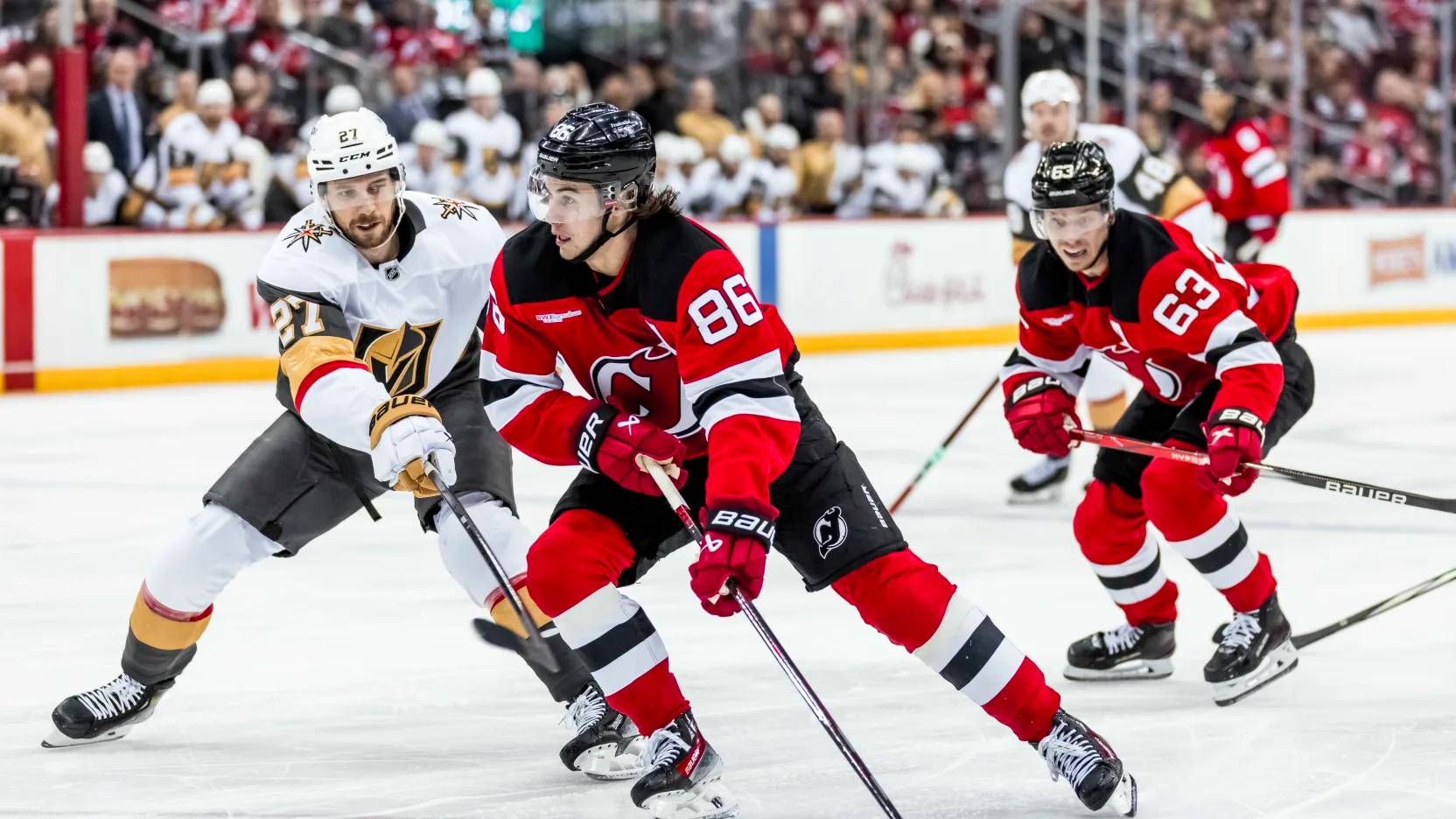 Jack Hughes handles the puck for the Devils in a game against the Golden Knights.