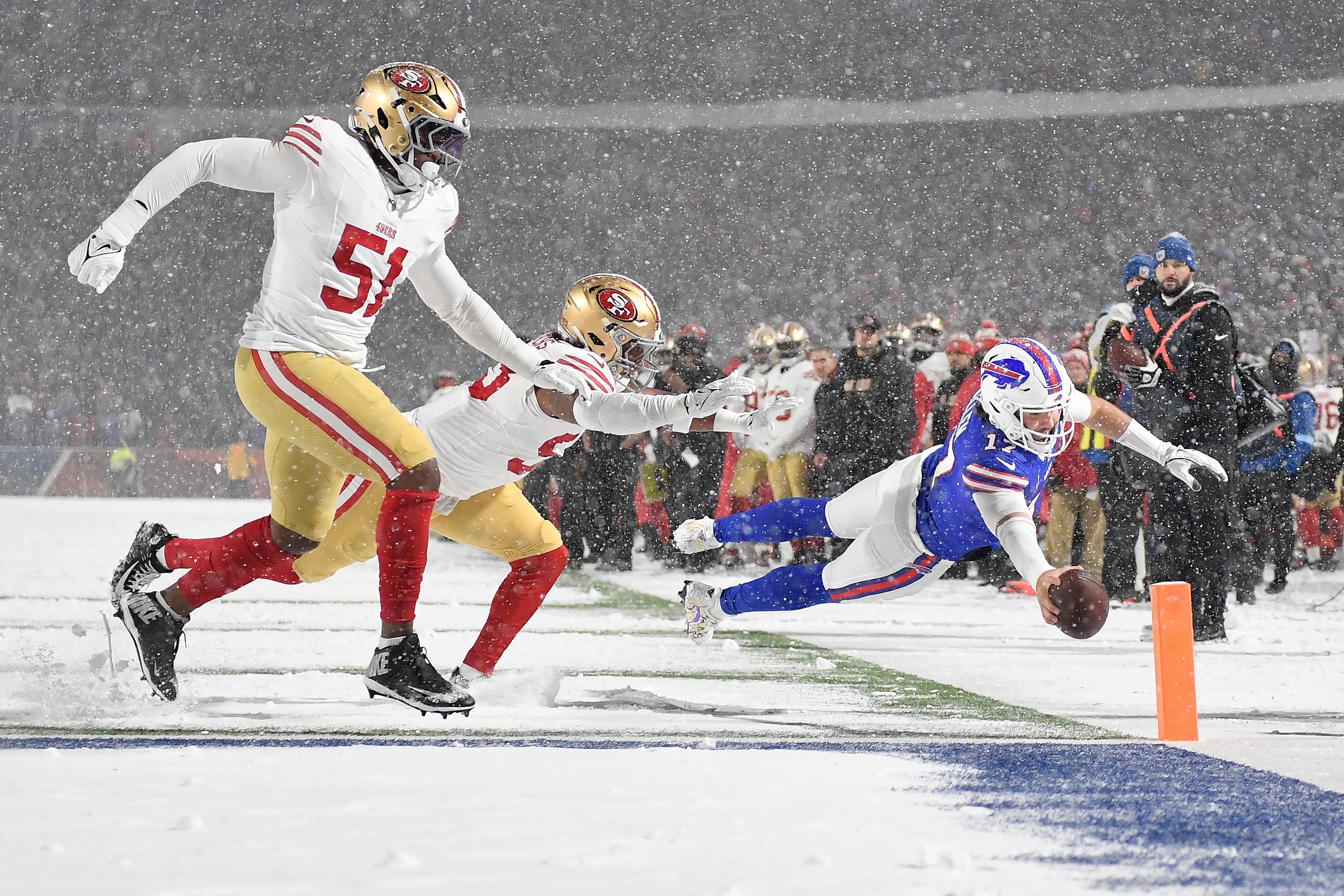 Josh Allen (right) dives for a touchdown against the San Francisco 49ers.