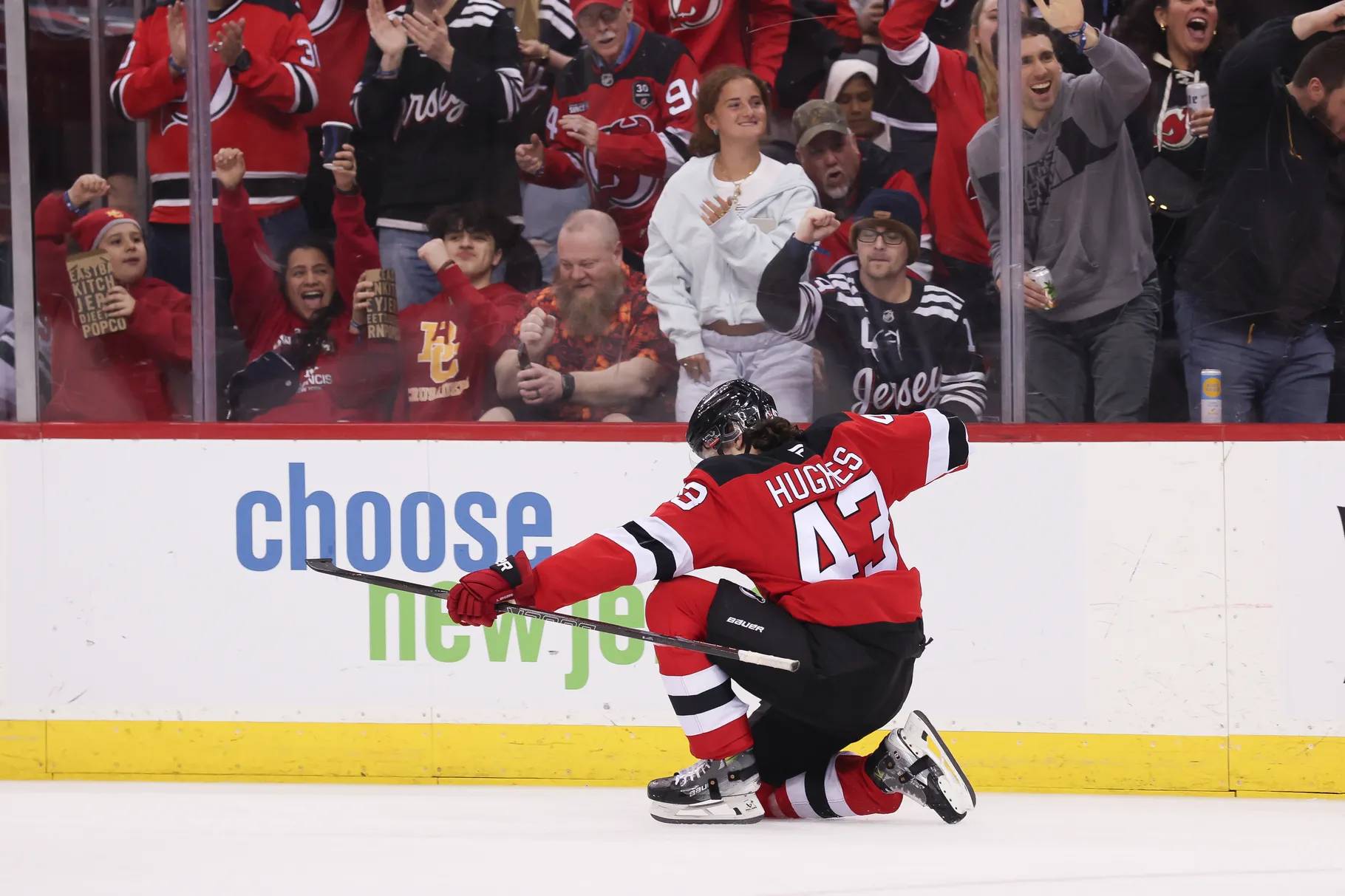 Luke Hughes celebrates on the ice during the Devils' shootout win on Monday night.