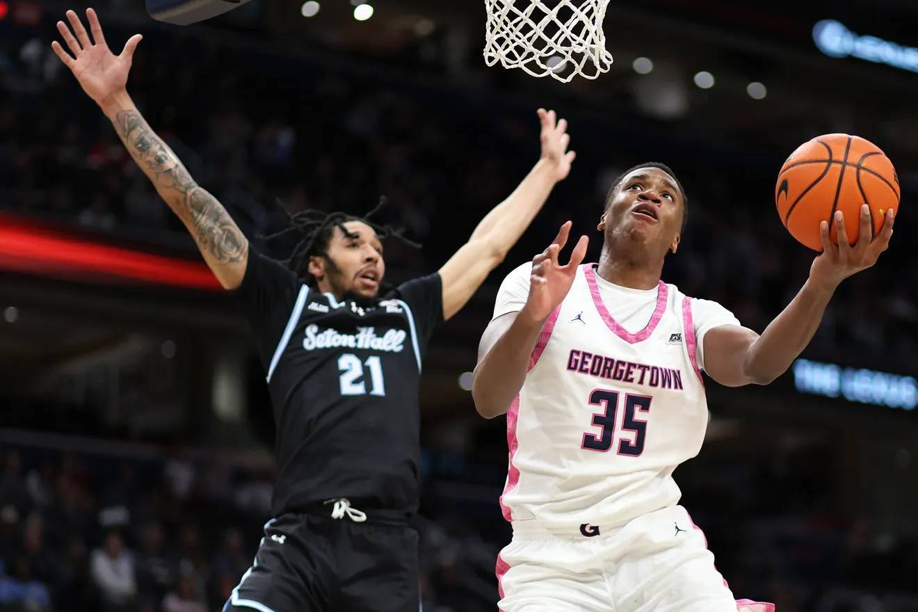 Isaiah Coleman (left) defends against Thomas Sorber (right), who goes to the basket for a layup.