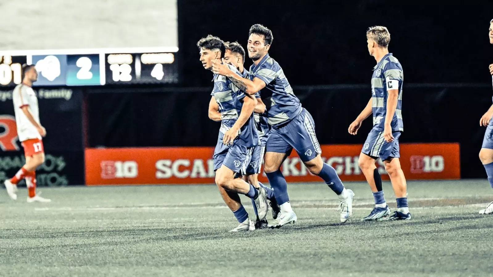 Seton Hall players celebrating a goal in a game against Rutgers.
