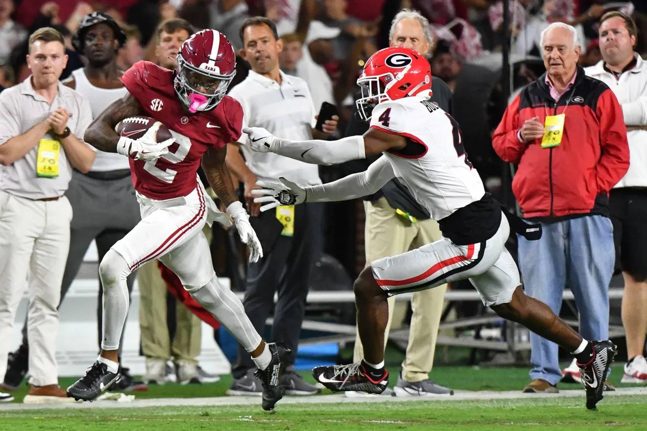 Ryan Williams (left) breaks a tackle from KJ Bolden (right) on his way to scoring a game-winning touchdown for the Crimson Tide.