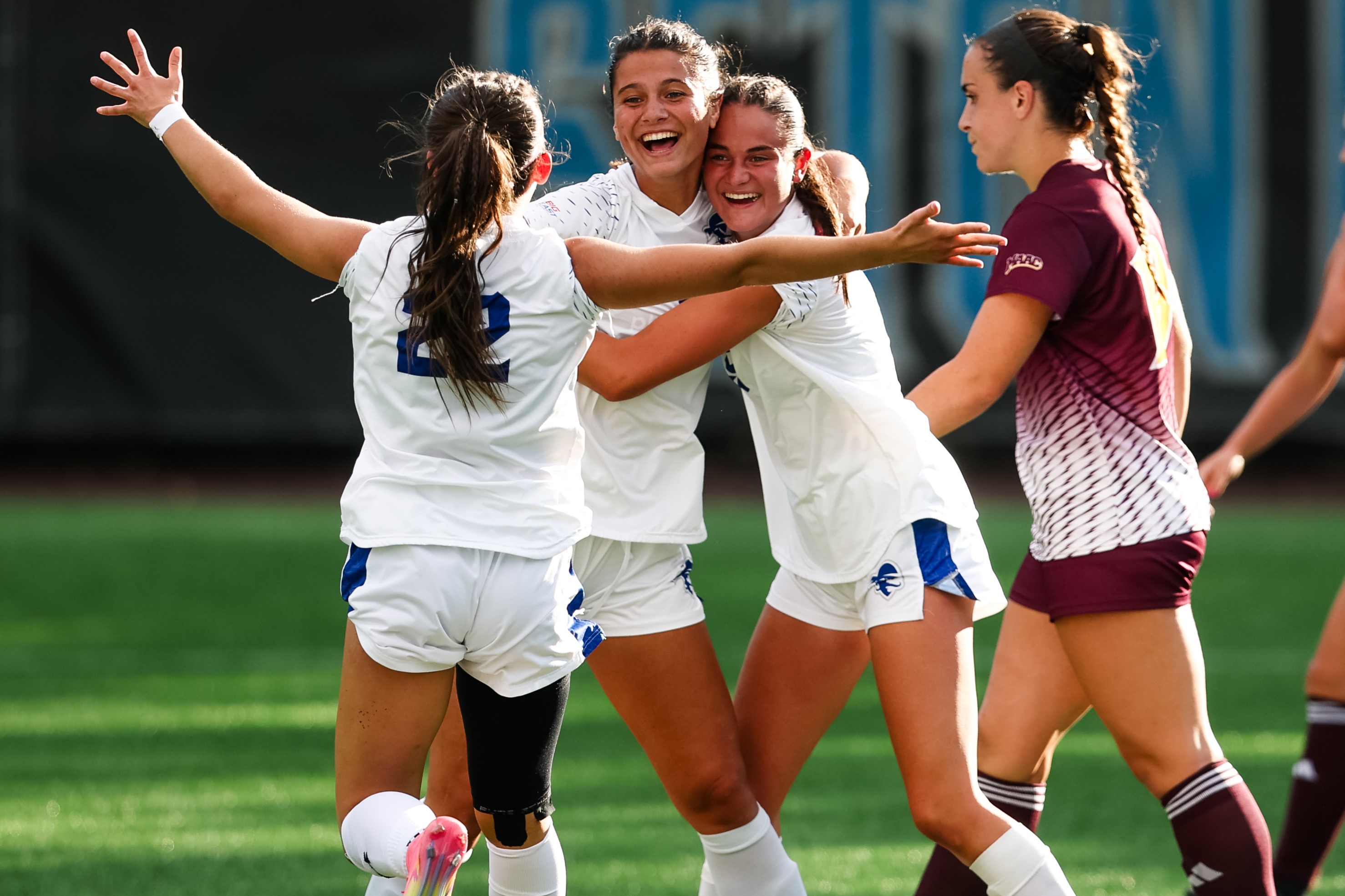 Paige Shaughnessy celebrating goal with teammates in Seton Hall Pirates 3-0 victory over Iona Gaels