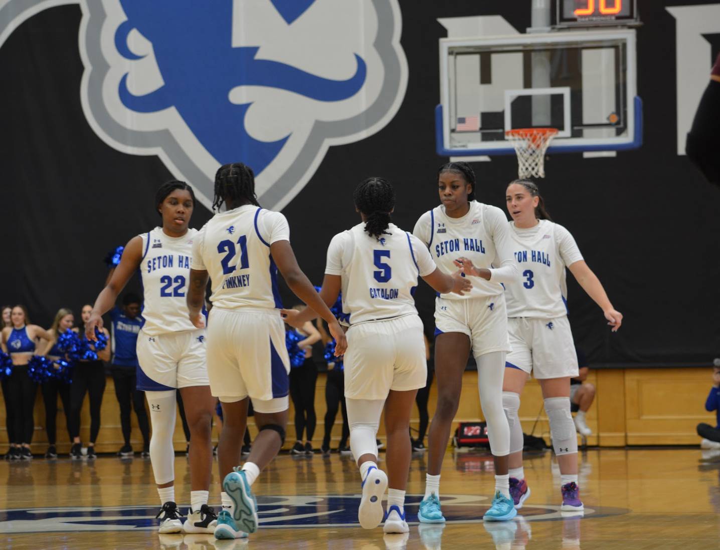 The starting 5 all high five each other