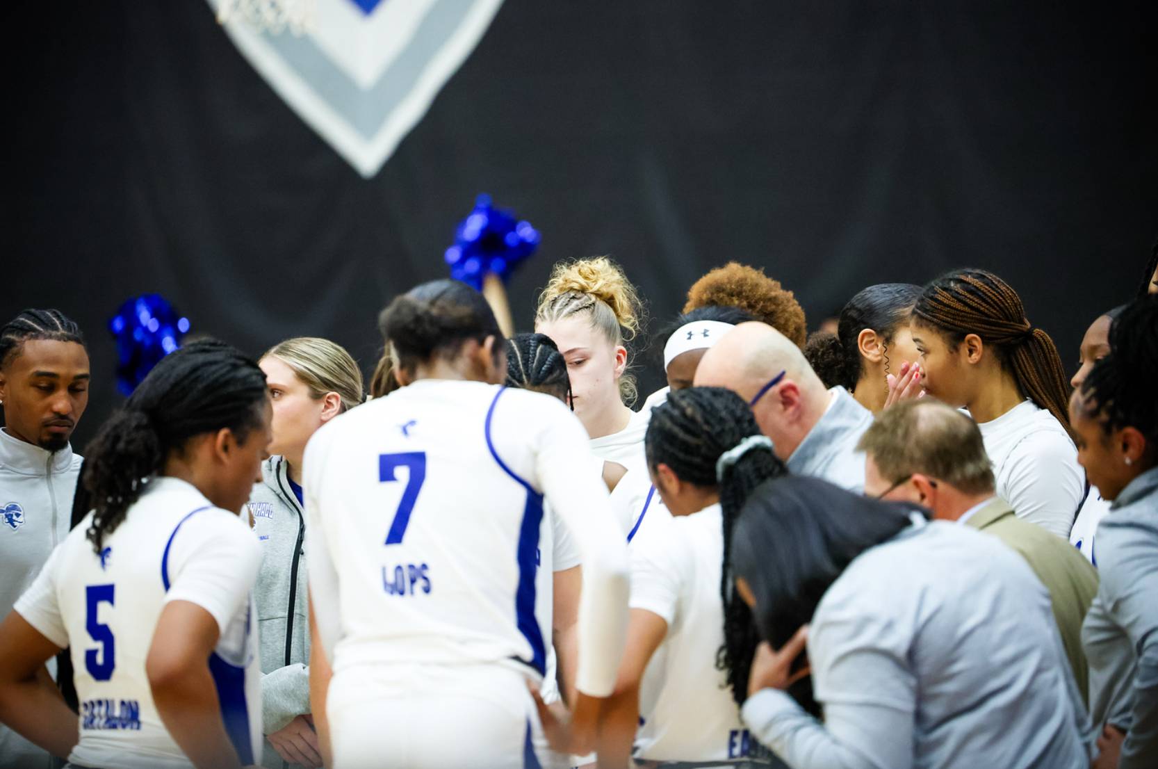 Women's basketball team in huddle