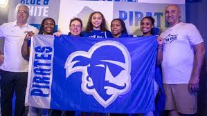 Zahara Bishop and family posing with Seton Hall Pirates flag